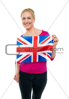 Cheerful female supporter holding national flag