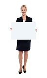 Businesswoman showing blank white billboard