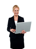 Corporate woman holding laptop