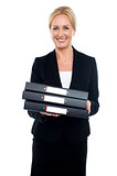 Female executive carrying business files