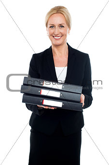 Female executive carrying business files