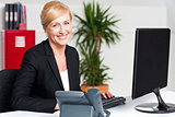 Smiling corporate woman typing on keyboard