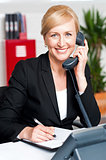 Corporate lady communicating on phone