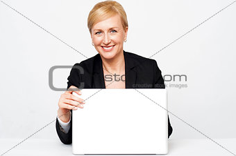 Secretary holding laptop flap, about to close