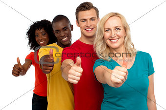 Smiling group of people with thumbs up gesture