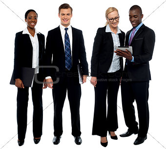 Corporate team of four posing with tablet pc