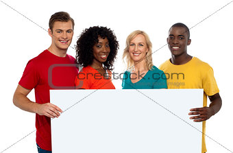 Group of youth displaying blank advertise board