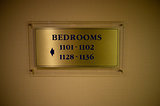 Board indicating direction to the bedrooms