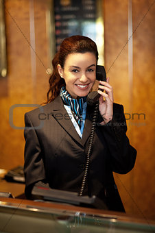 Stylish female attendant at hotel reception