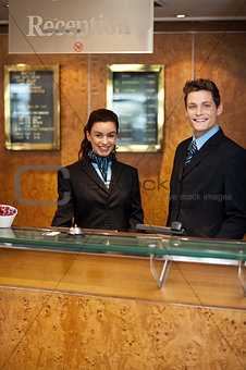 Trendy adorable couple at front office desk