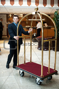Casual shot of a concierge pushing the cart