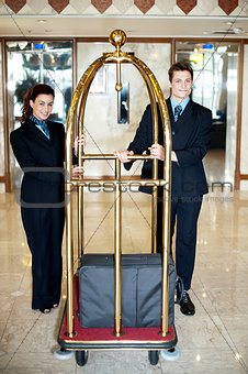 Concierge colleagues holding baggage cart