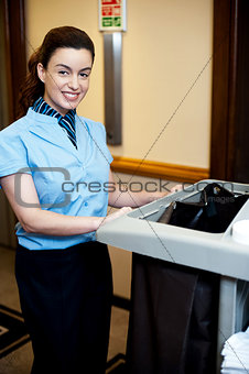 Female attendant posing with cart