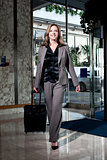 Stylish businesswoman entering the hotel
