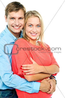 Happy man embracing his wife from behind