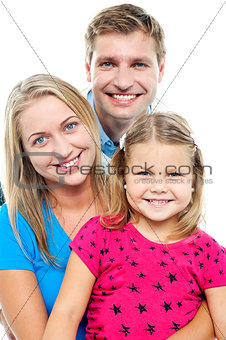 Parents posing with cute smiling daughter