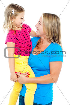 Gorgeous mother holding her beautiful daughter in arms