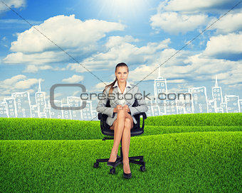 Young Businesswoman Sitting on Chair at Grassland