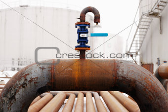 blue valve on rusty piping