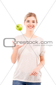 Beautiful woman throwing a green apple