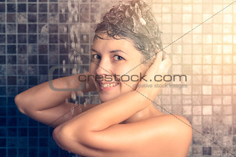 Woman shampooing her long brown hair