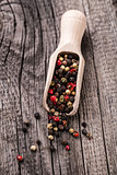 Wooden spoon full of mix pepper
