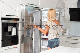 commercial cute girl in front of refrigerator
