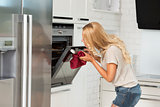 commercial girl looking food in oven