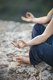 Close up of female hand zen gesturing. Girl sits in asana position.
