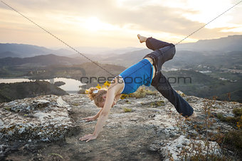 Young Caucasian woman performing yoga pose outdoors