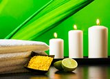 Spa massage border background with towel stacked sea salt candles and lime
