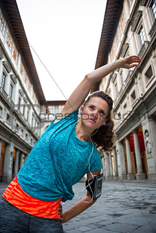 Fitness woman stretching near uffizi gallery in florence, italy