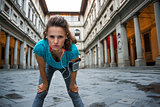 Fitness woman catching breathe near uffizi gallery in florence, 