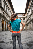 Fitness woman standing in front of uffizi gallery in florence, i