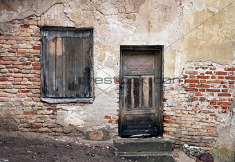 Old window and door with cracked wall