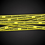 Under construction on tape on metal background