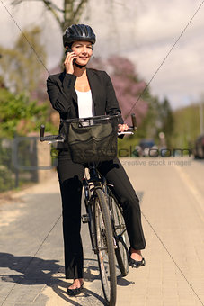 Businesswoman riding to work pausing for a call