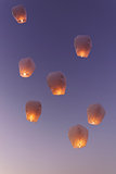 Sky lanterns flying upwards 