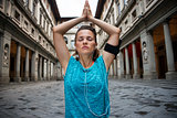 Fitness woman doing yoga near uffizi gallery in florence, italy