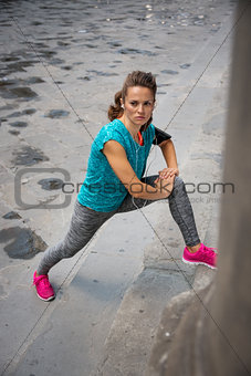 Fitness young woman stretching outdoors