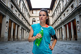 Fitness woman with bottle of water near uffizi gallery in floren