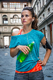 Fitness woman with bottle of water near uffizi gallery in floren