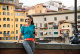 Fitness woman standing near ponte vecchio in florence, italy