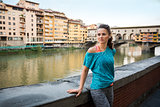 Fitness woman standing near ponte vecchio in florence, italy and