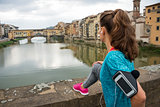 Fitness woman looking on ponte vecchio in florence, italy