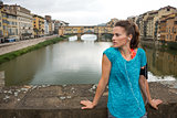 Fitness woman standing in front of ponte vecchio in florence, it