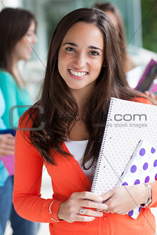 Smiling teenager with exercise books