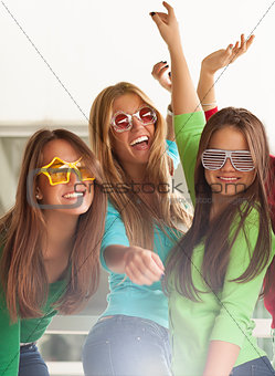 Smiling teenagers with funny glasses