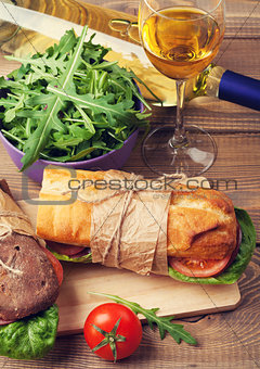 Two sandwiches and white wine glass