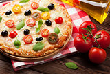 Italian pizza with cheese, tomatoes and basil